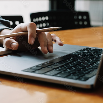 Hand hovering over a laptop keyboard