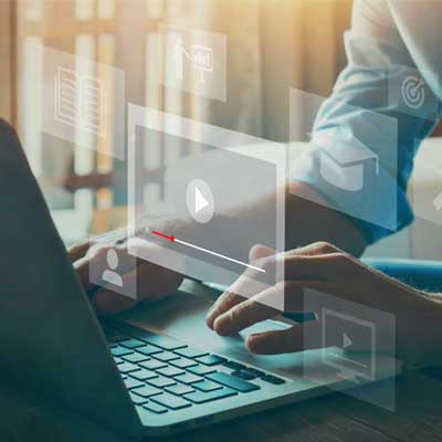 Person's hands typing on a laptop keyboard.